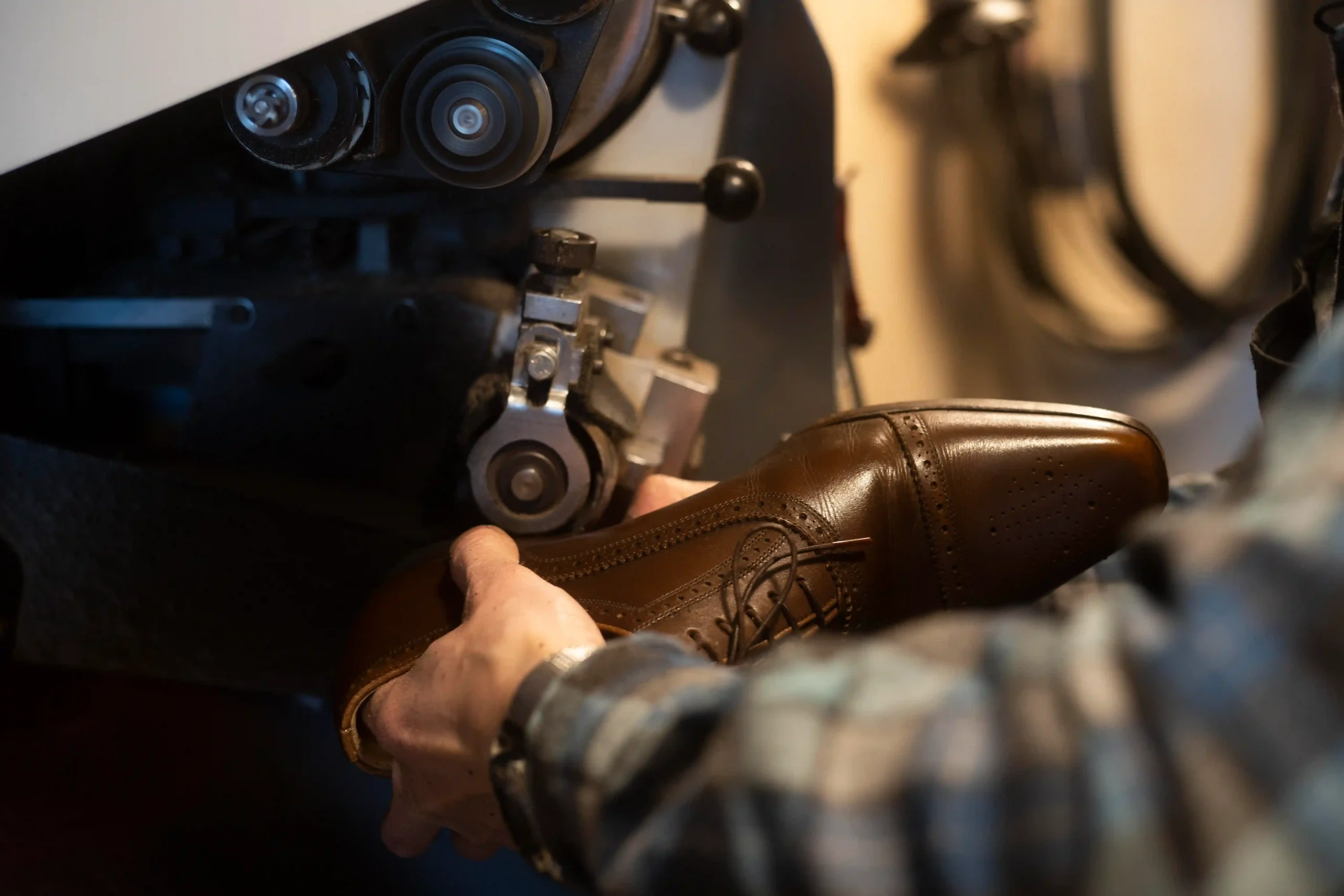 The hand close by is making a shoe.