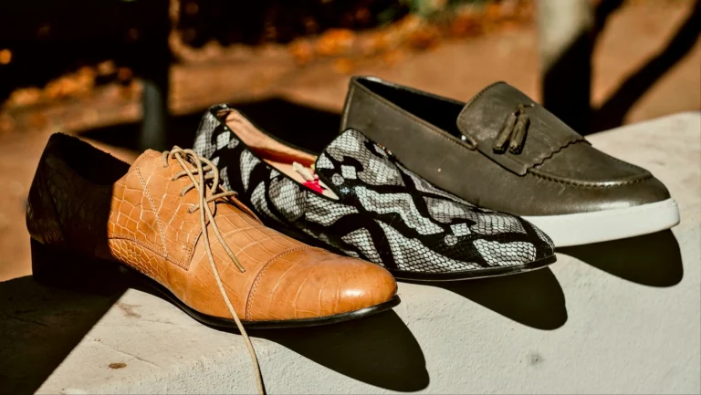 image shows three pairs of leather shoes, with distinctive designs, including a crocodile-textured brown pair, a black-and-white patterned pair