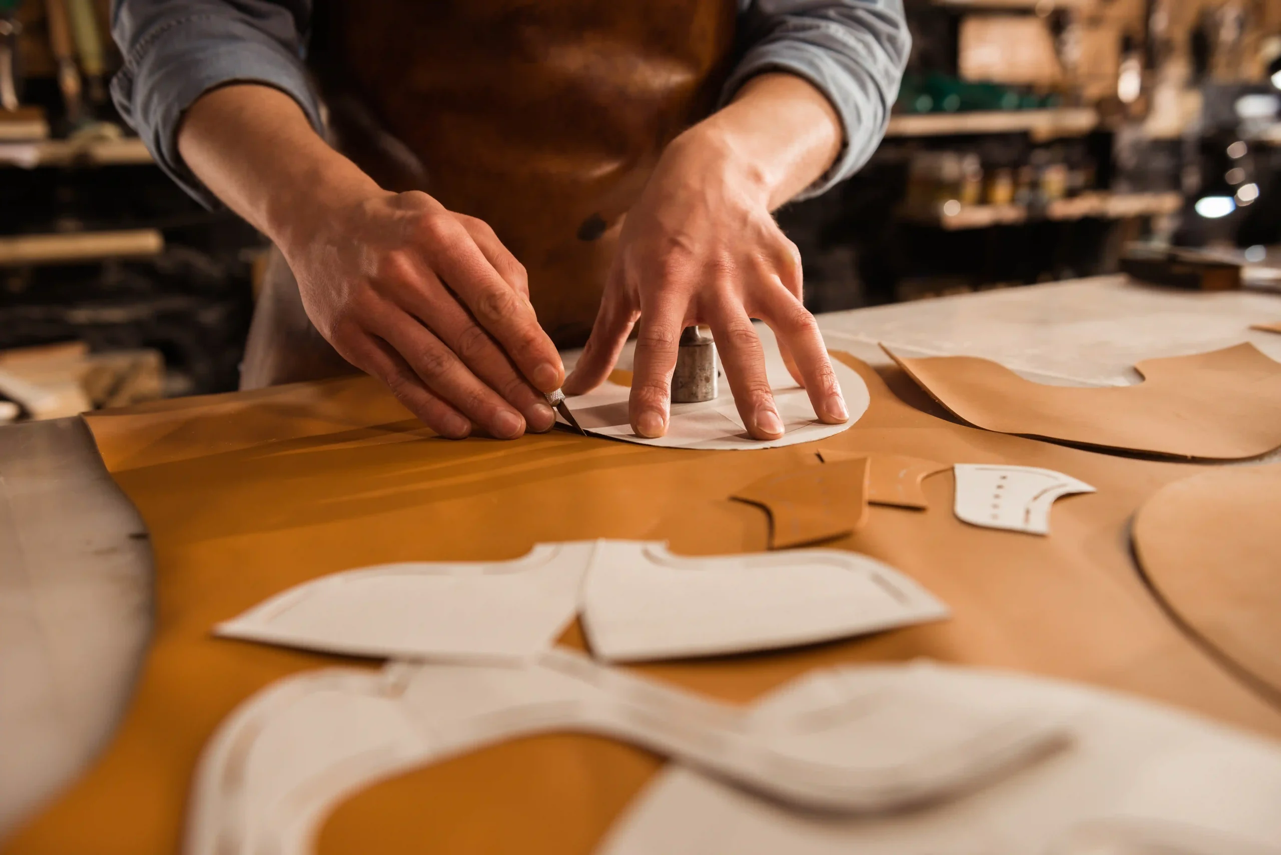 close-up-male-shoemaker-cutting-leather-textile