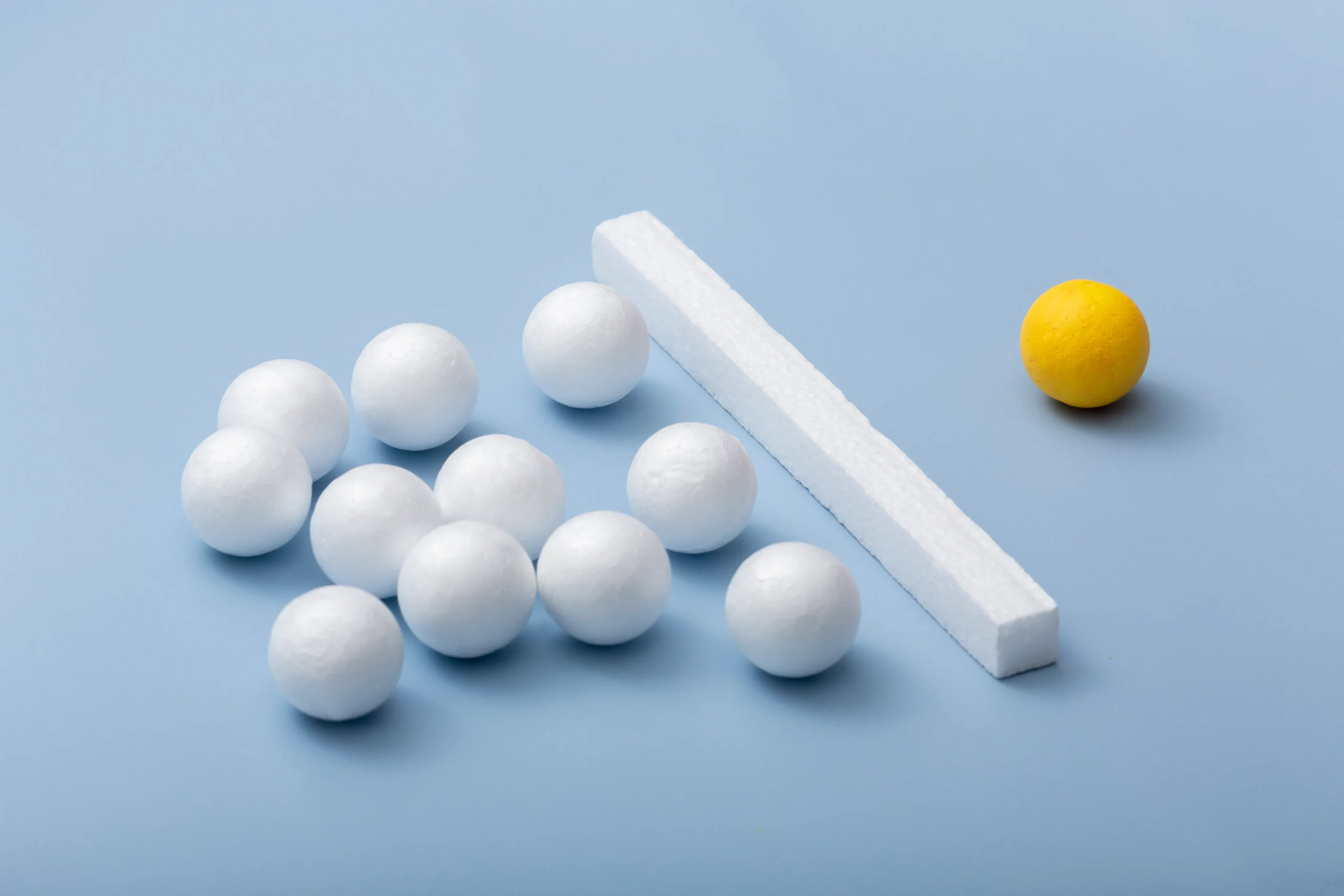 Two differently colored spheres along with a long white rectangle