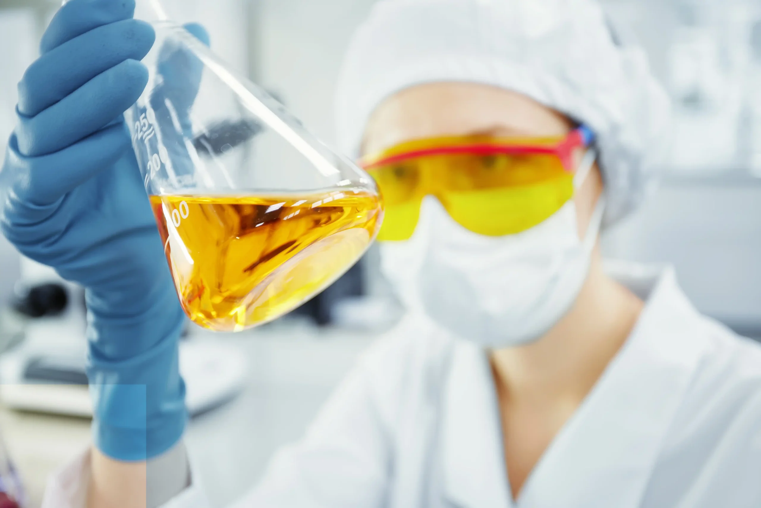 close up portrait young woman s hands holding test tube with yellow liquid