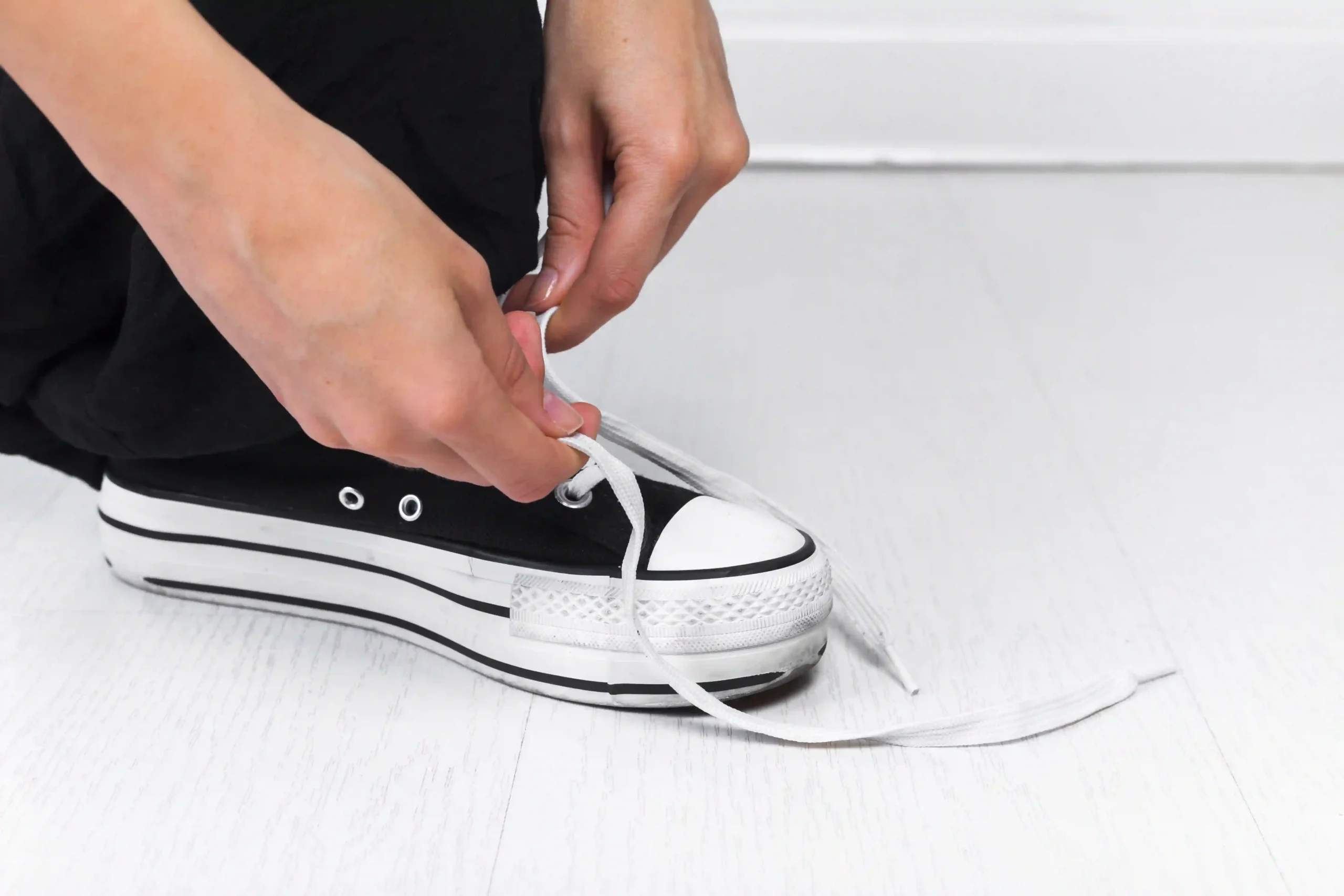 human hand tying shoelace